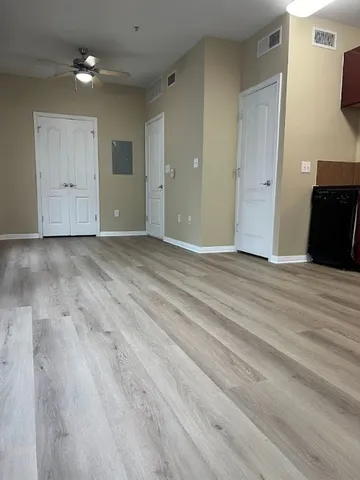a view of a kitchen with a stove cabinets and wooden floor