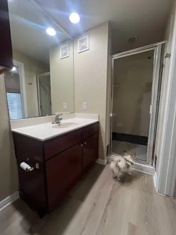 a bathroom with a granite countertop sink a toilet and a mirror