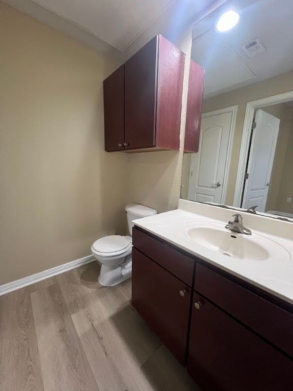 2505 San Gabriel Street, Unit 101 Austin, TX 78705 - Photo 8 of 9 a bathroom with a granite countertop sink a toilet and a mirror