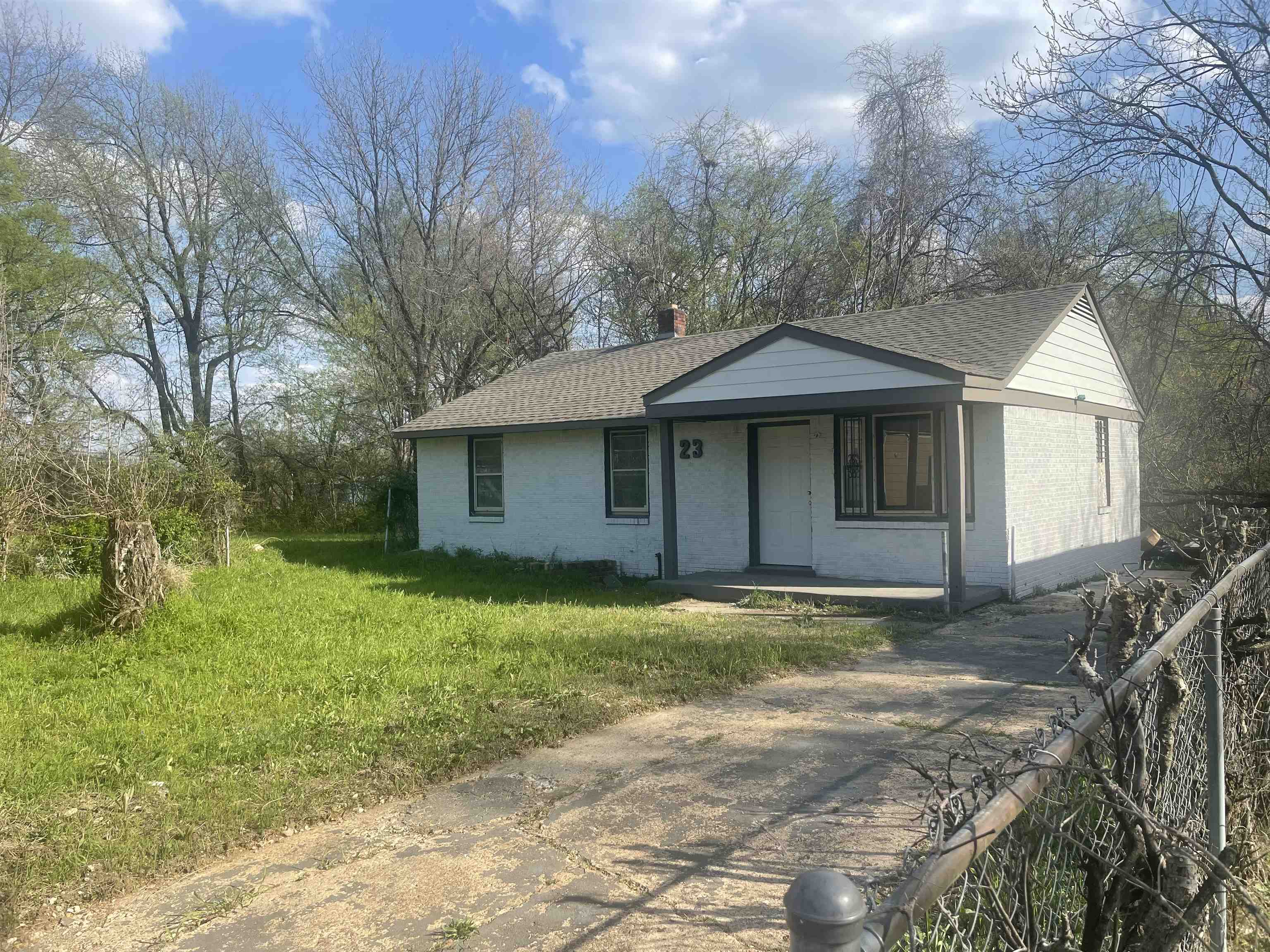 23 Fields Avenue Memphis, TN 38109 - Photo 2 of 4 View of front of home featuring covered porch, roof with shingles, brick siding, and a chimney
