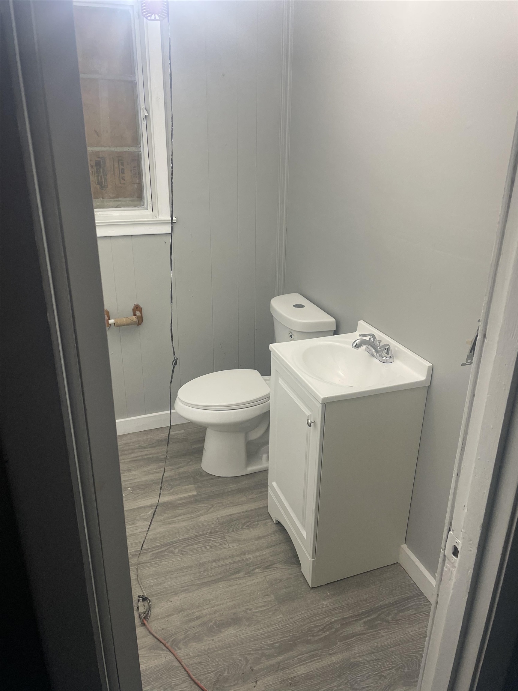 23 Fields Avenue Memphis, TN 38109 - Photo 3 of 4 Half bath with vanity and dark wood-type flooring