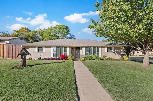 a view of a house with a yard and garden