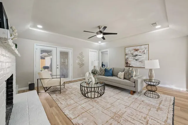 a living room with furniture a fireplace and a flat screen tv