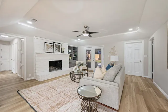 a living room with furniture a fireplace and a table