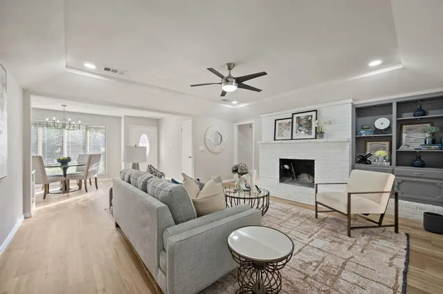 a living room with furniture a fireplace and a table