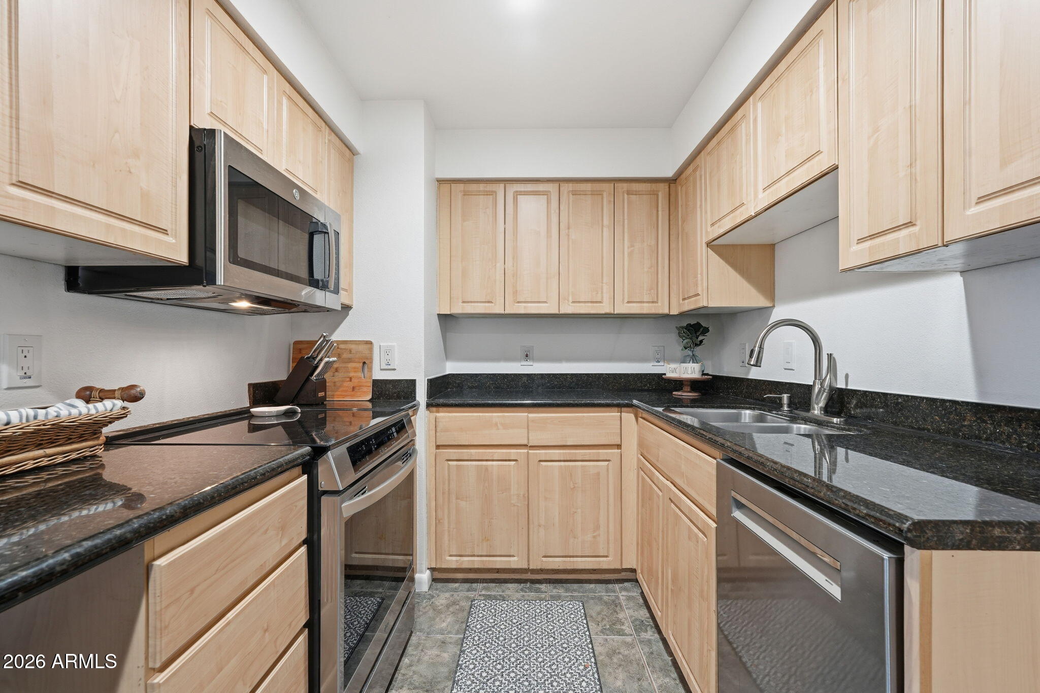 1005 East 8th Street, Unit 2003 Tempe, AZ 85281 - Photo 11 of 38 a kitchen with granite countertop a sink stainless steel appliances and cabinets