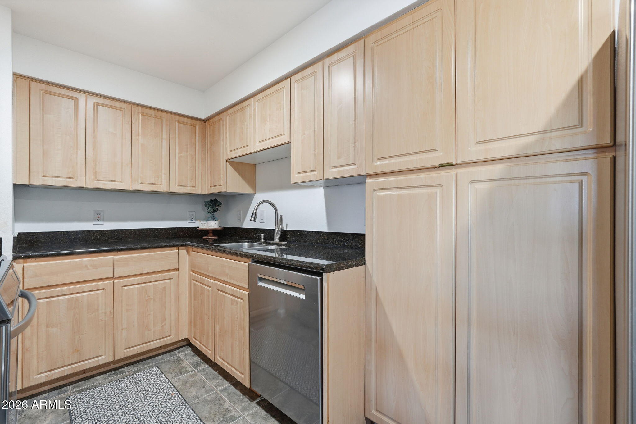 1005 East 8th Street, Unit 2003 Tempe, AZ 85281 - Photo 10 of 38 a kitchen with stainless steel appliances granite countertop a sink and a white cabinets