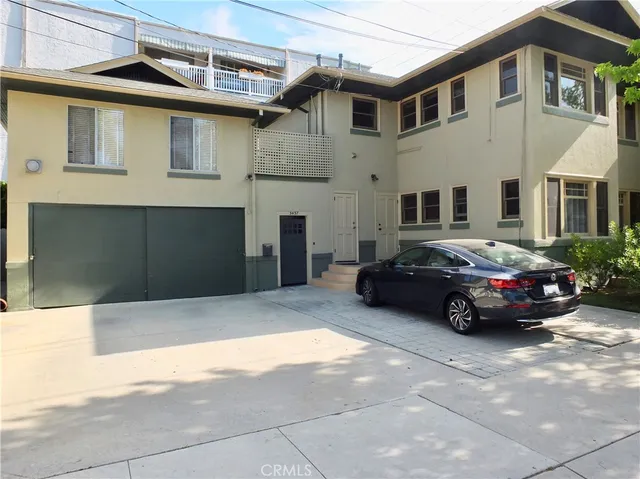 a car parked in front of a white building