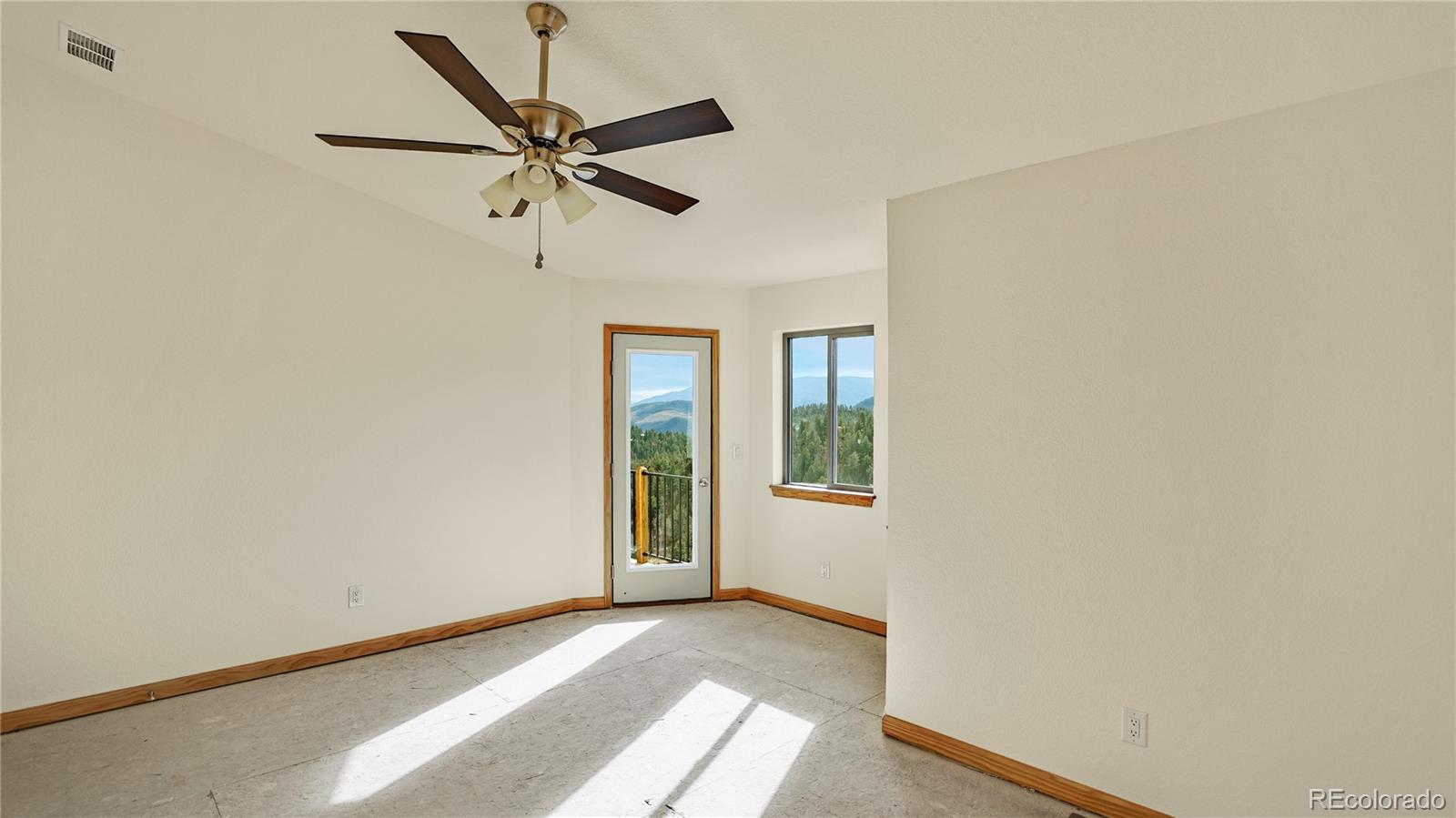 209 Fawn Road Bailey, CO 80421 - Photo 13 of 26 a view of a livingroom with a ceiling fan and window
