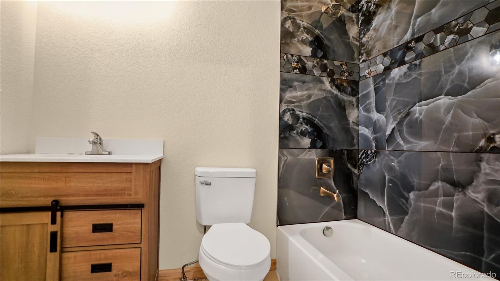 209 Fawn Road Bailey, CO 80421 - Photo 17 of 27 a bathroom with a toilet sink and tub