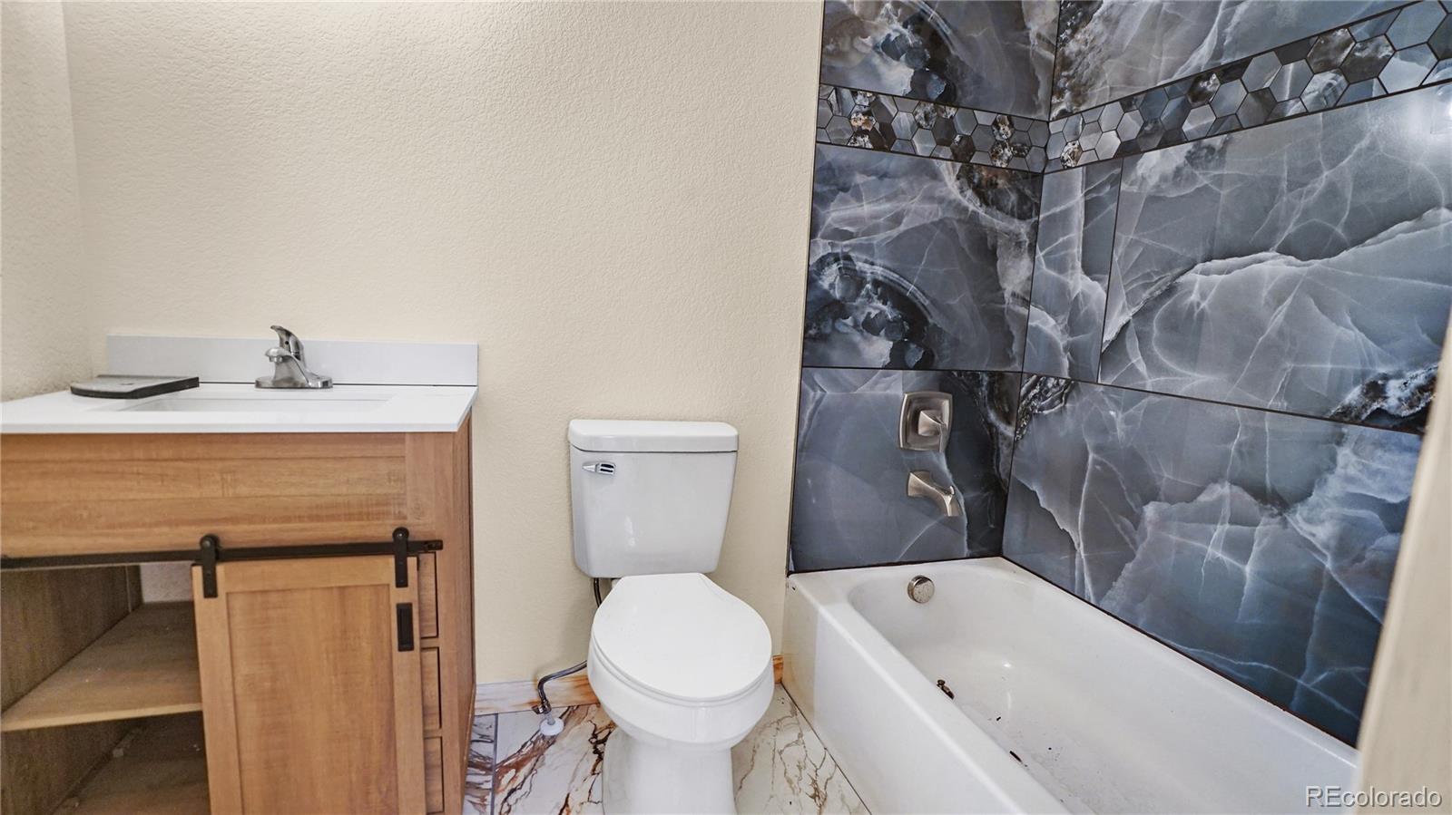 209 Fawn Road Bailey, CO 80421 - Photo 19 of 26 a bathroom with a granite countertop sink toilet and shower