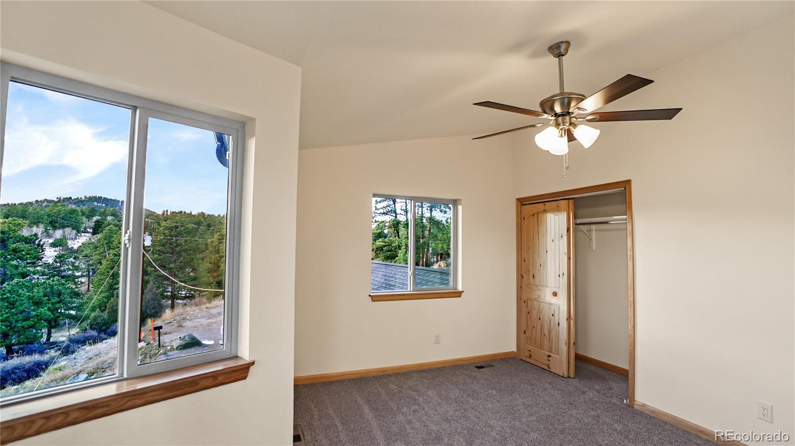 209 Fawn Road Bailey, CO 80421 - Photo 20 of 27 a view of a livingroom with a ceiling fan and a large window
