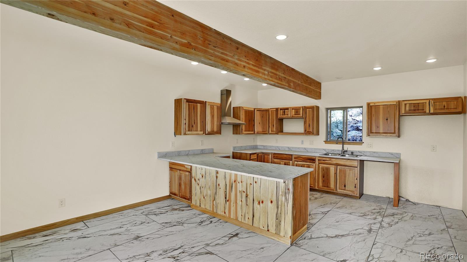 209 Fawn Road Bailey, CO 80421 - Photo 5 of 26 a kitchen with a sink and cabinets