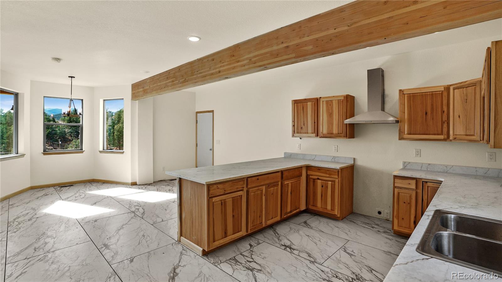 209 Fawn Road Bailey, CO 80421 - Photo 7 of 26 a kitchen with stainless steel appliances granite countertop a stove a sink and a microwave