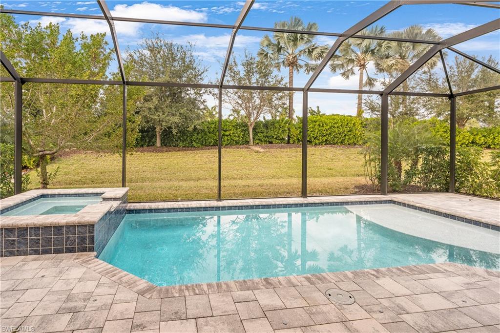 14586 Kelson Circle Naples, FL 34114 - Photo 11 of 35 a view of a swimming pool with a chair and floor