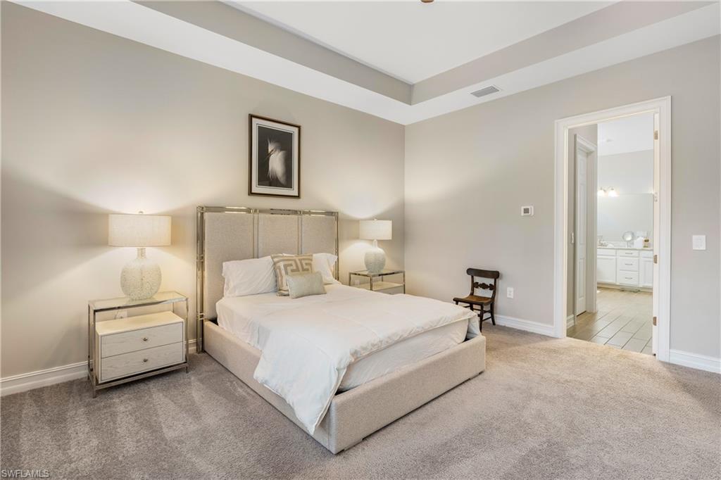 14586 Kelson Circle Naples, FL 34114 - Photo 15 of 35 a bedroom with a bed and a lamp