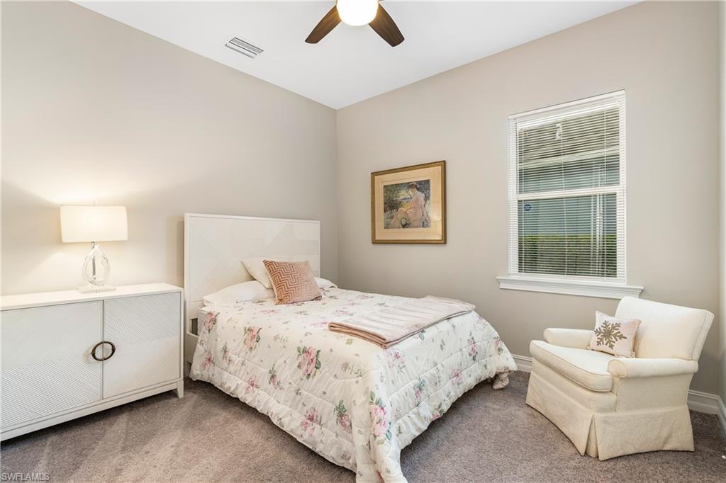 14586 Kelson Circle Naples, FL 34114 - Photo 17 of 35 a bedroom with a bed and a chandelier fan