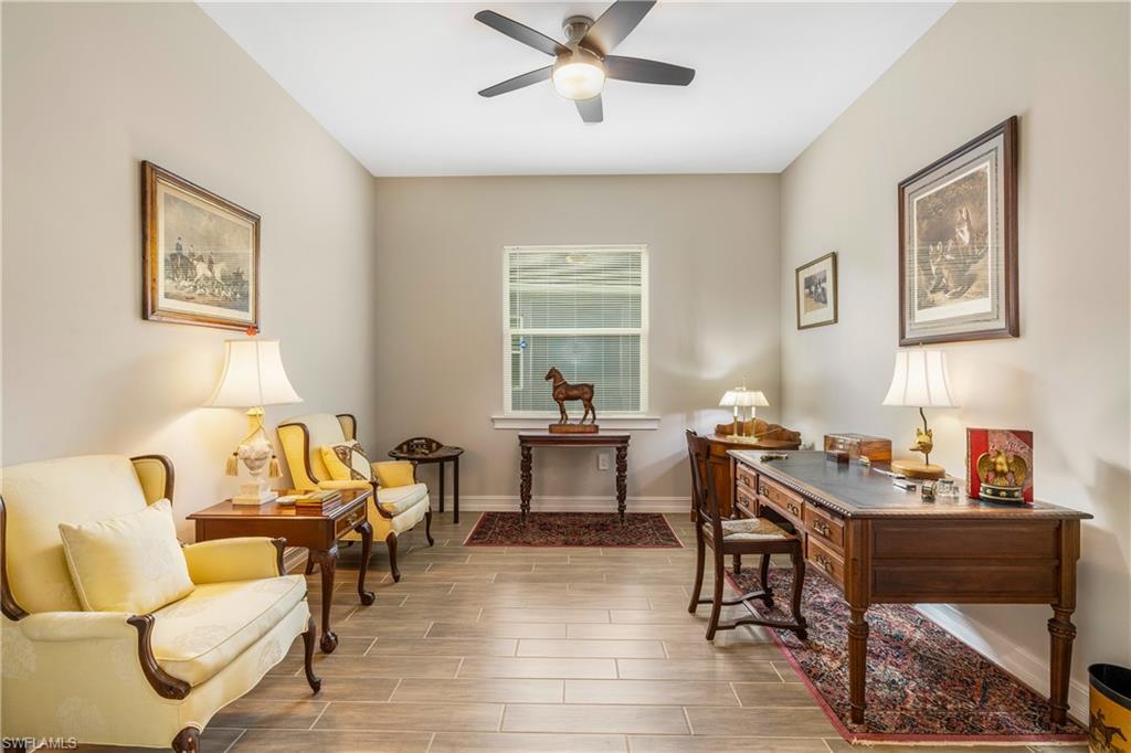 14586 Kelson Circle Naples, FL 34114 - Photo 21 of 35 a living room with furniture and a wooden floor
