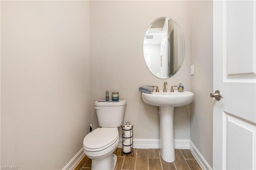 14586 Kelson Circle Naples, FL 34114 - Photo 22 of 35 a bathroom with a toilet sink and mirror