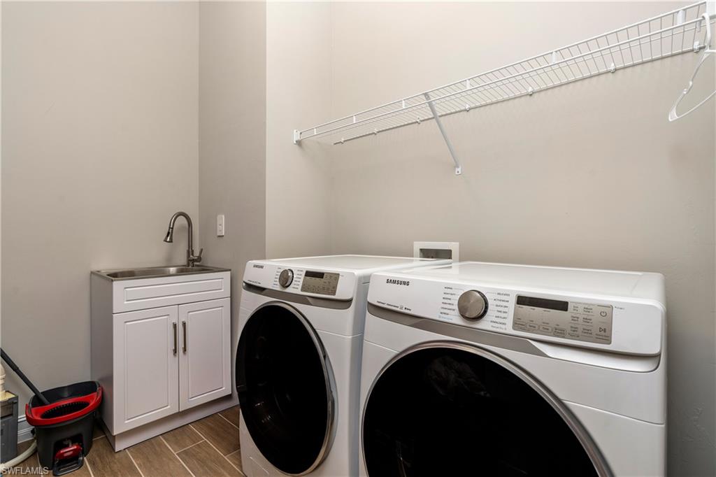 14586 Kelson Circle Naples, FL 34114 - Photo 23 of 35 a utility room with dryer and washer