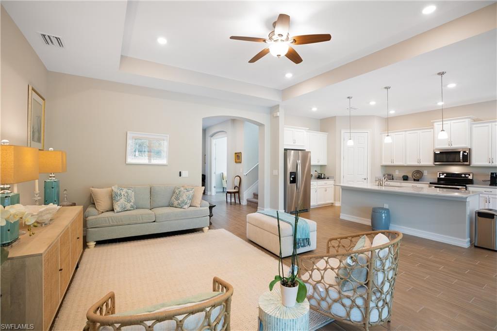 14586 Kelson Circle Naples, FL 34114 - Photo 6 of 35 a living room with furniture kitchen view and a chandelier