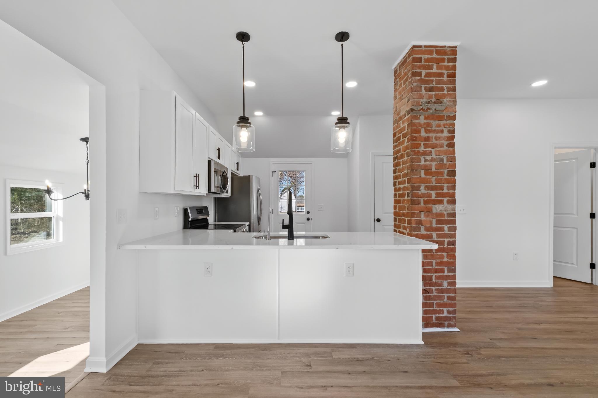 28272 Riverside Drive Salisbury, MD 21801 - Photo 27 of 33 Modern kitchen with rustic brick accents.