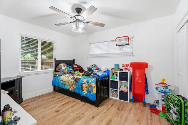 a view of a play room with furniture and toys