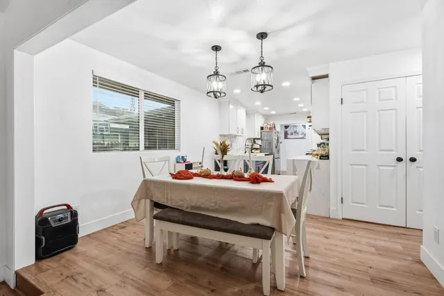 a view of a dining room with furniture and wooden floor