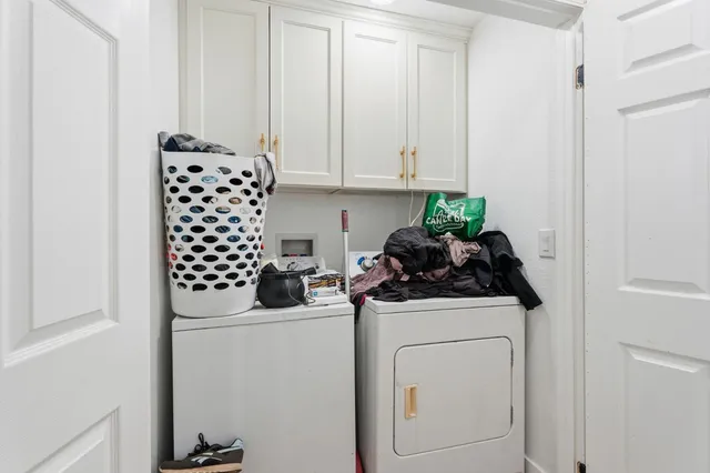 a bedroom with bed and a chandelier