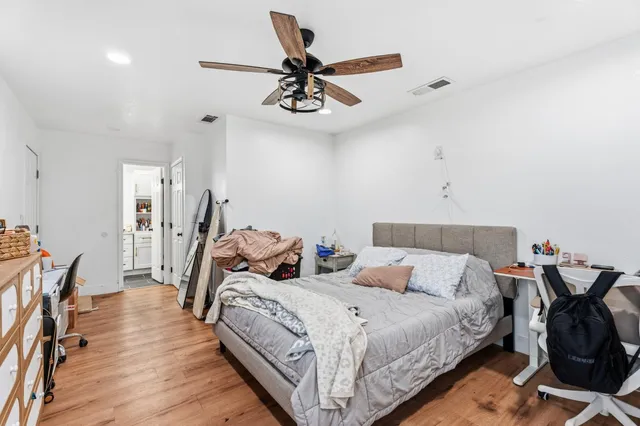 a bedroom with a bed and a chandelier