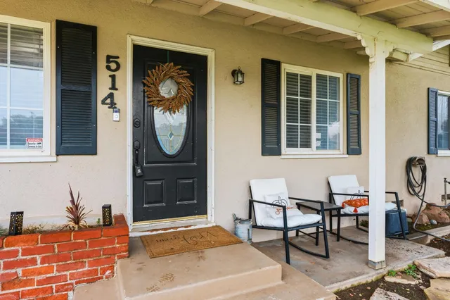 a living room with furniture a window and a potted plant