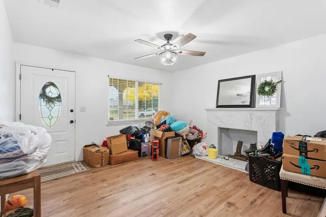 a living room with furniture fireplace and a window