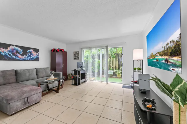 a living room with furniture and a floor to ceiling window