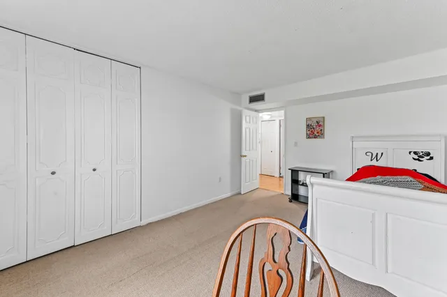 a view of a kitchen with a sink and a refrigerator