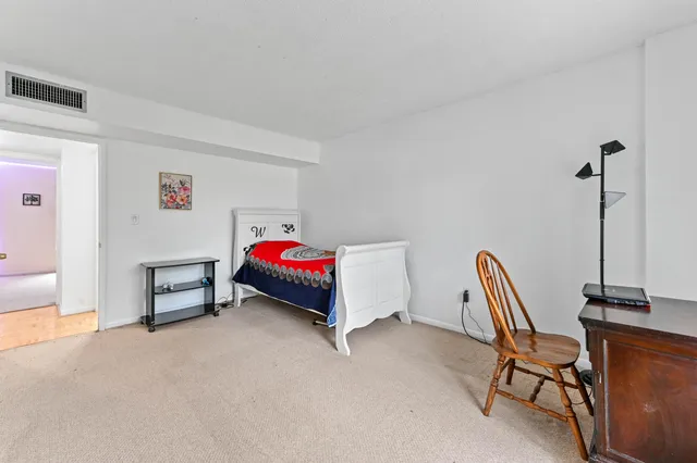 a bedroom with furniture and a window