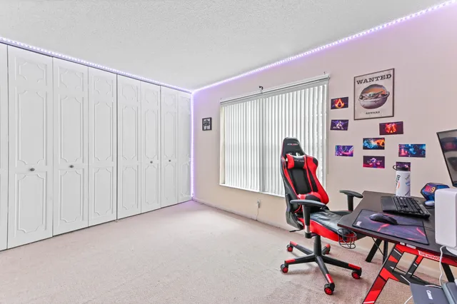 a view of a workspace with furniture and wooden floor