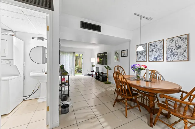 a dining room with furniture and a chandelier