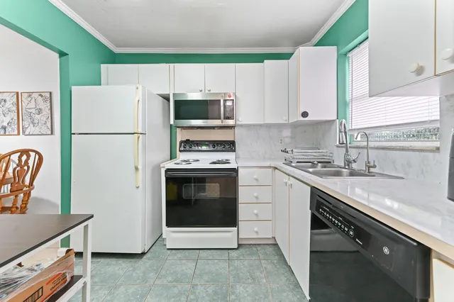 a kitchen with cabinets stainless steel appliances and a sink