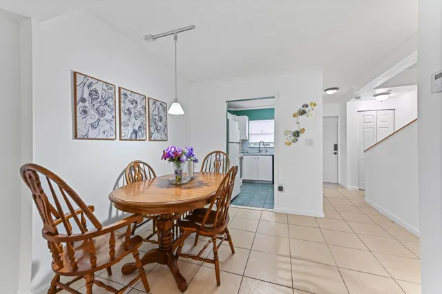 a view of a dining room with furniture and a chandelier