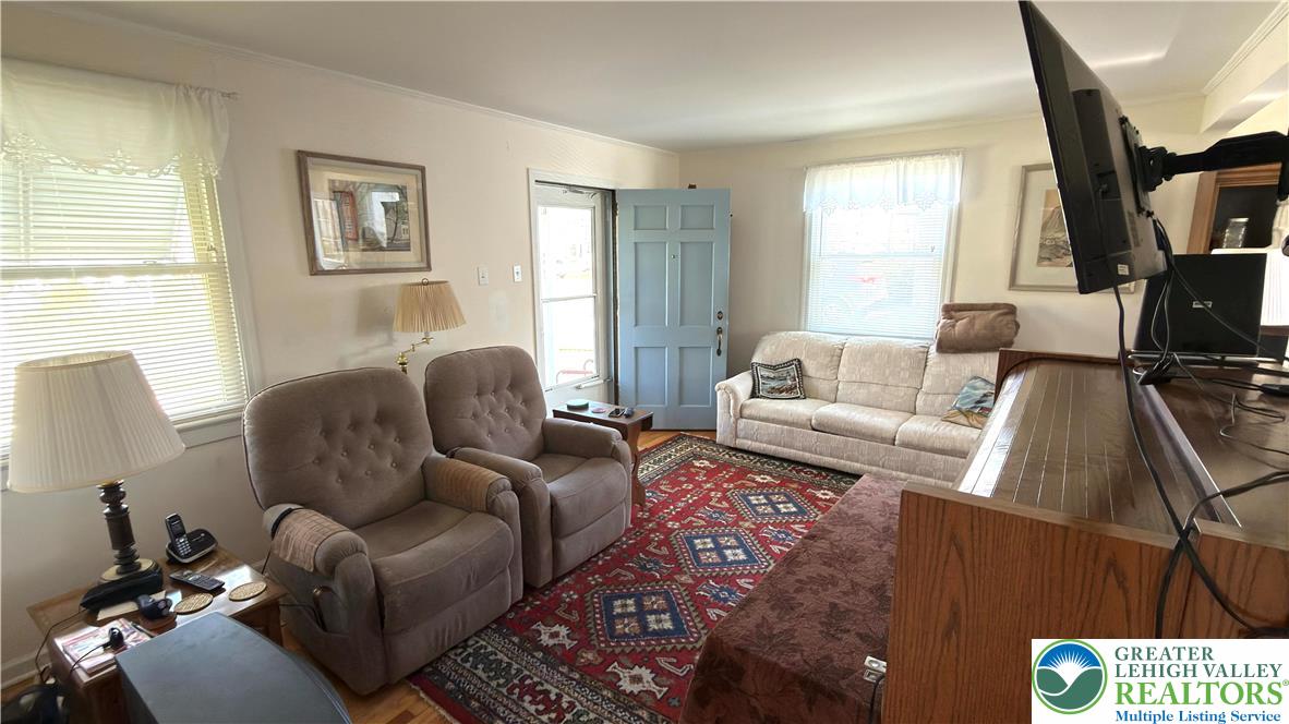 462 Maple Road Hellertown, PA 18055 - Photo 12 of 25 a living room with furniture a window and a flat screen tv