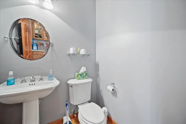 a white toilet sitting next to a bathroom sink