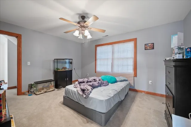 a living room with furniture chandelier and a flat screen tv