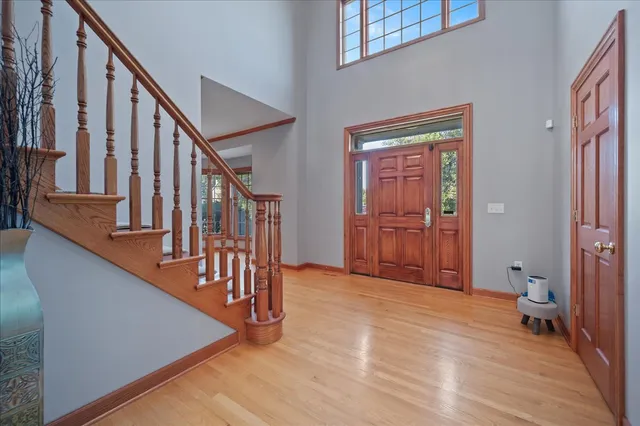 a view of a hallway with wooden floor and staircase