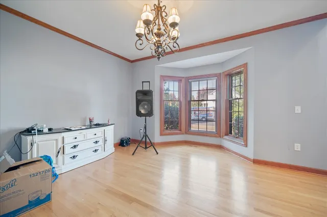 a view of a bedroom with furniture window and a chandelier
