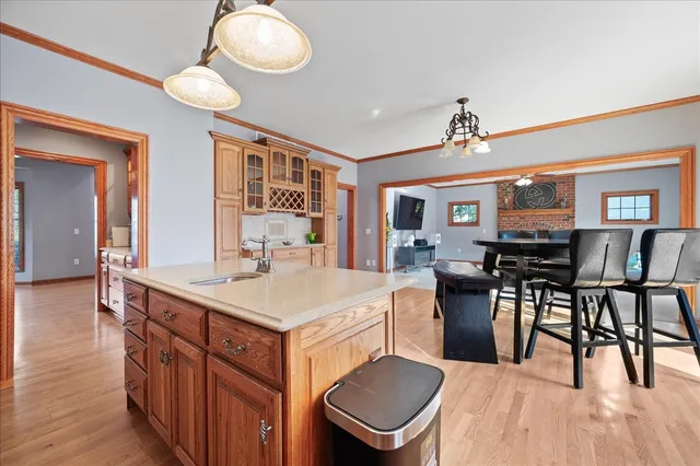 a large kitchen with kitchen island a dining table chairs and a chandelier
