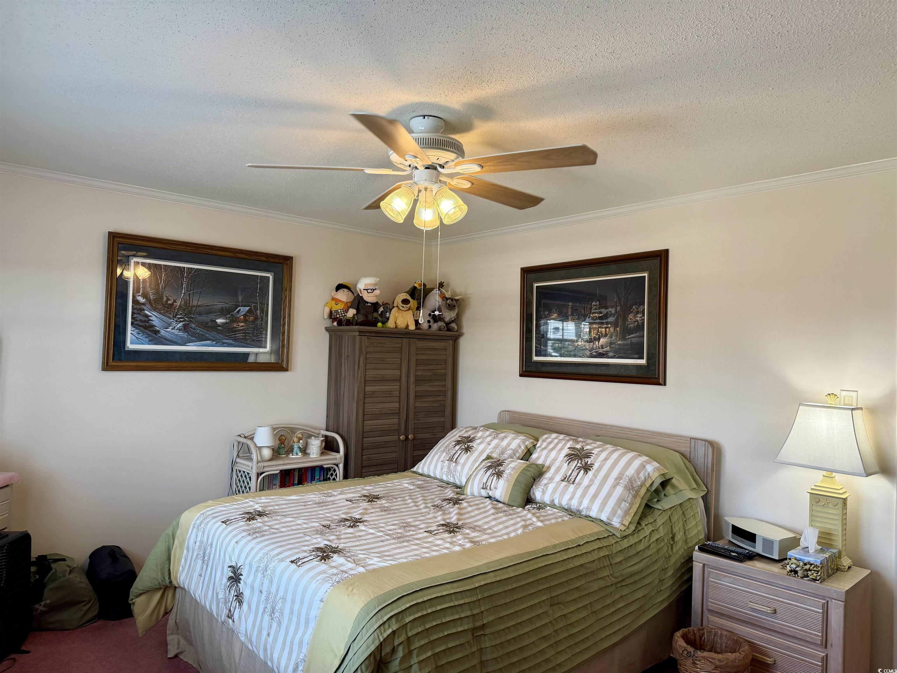 1506 Mason Circle Surfside Beach, SC 29575 - Photo 15 of 33 Bedroom featuring ornamental molding, a textured ceiling, a ceiling fan, and carpet