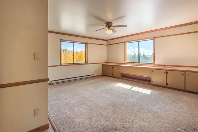 a bathroom with a toilet window and vanity