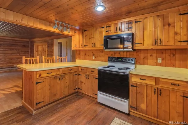 a kitchen with stainless steel appliances a stove sink and microwave
