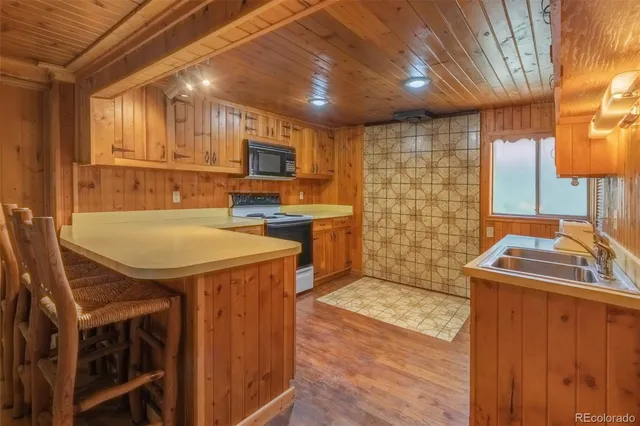 a view of a hallway with wooden floor and dining room