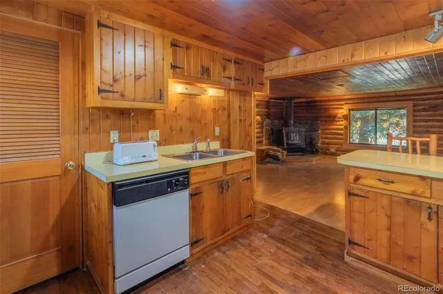 a kitchen with stainless steel appliances granite countertop a sink stove and wooden cabinets